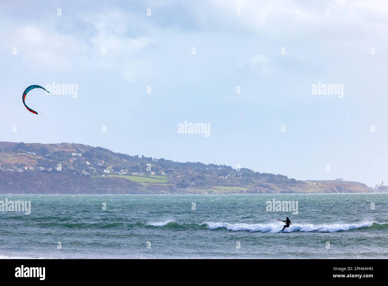 Dublin, Ireland March 2023 Kite surfer riding waves at Dollymount