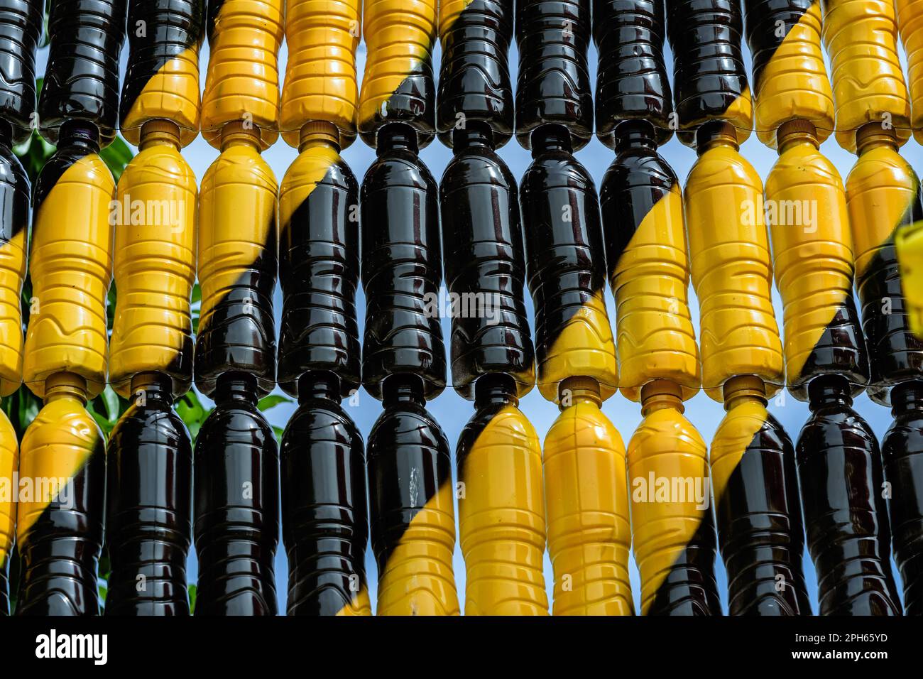 Beautiful wall made of multi colored recycled plastic bottles. Bottle