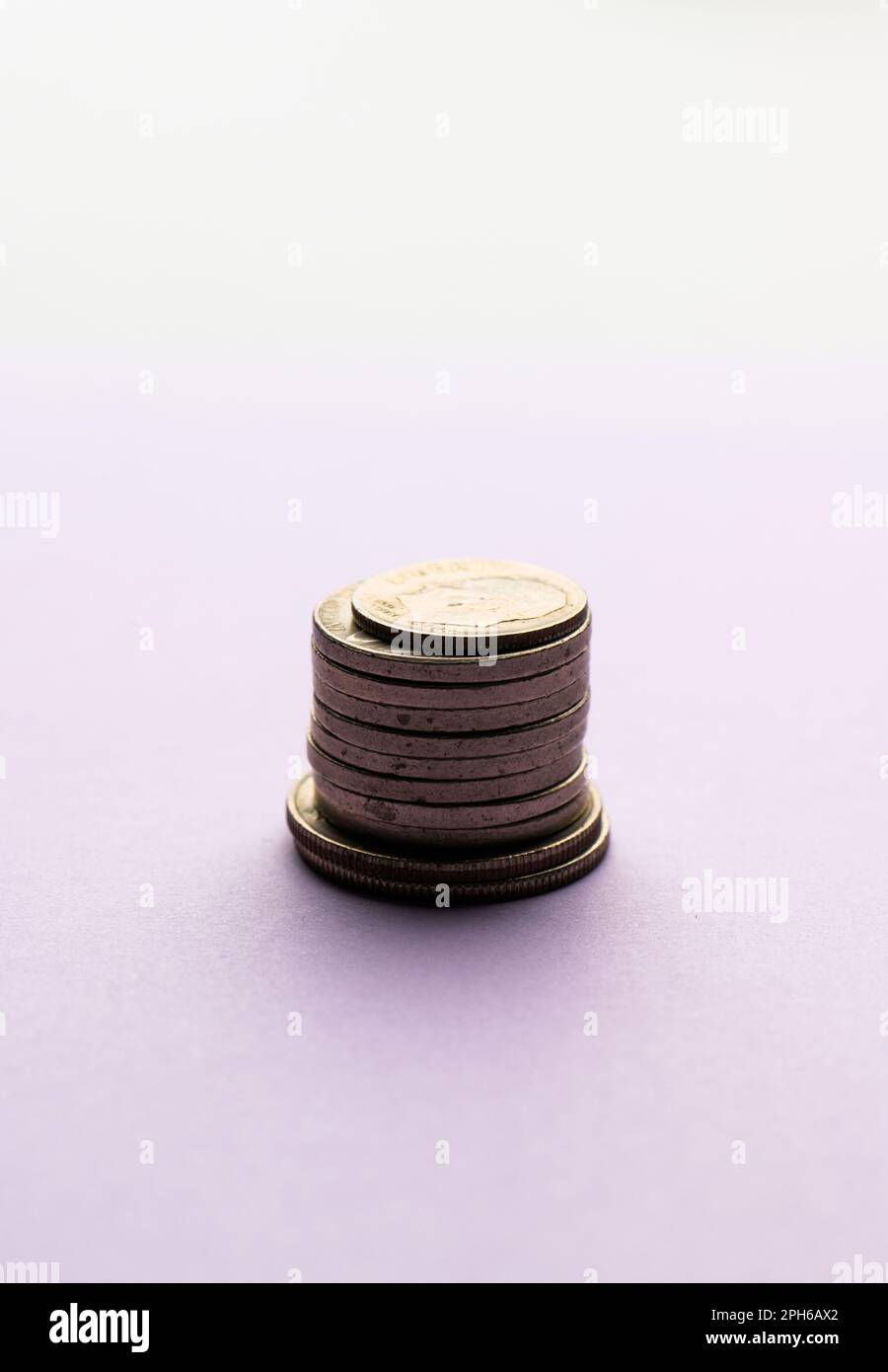 Canadian Dollar coins loonies stacked into five ascending piles on white  background. Stock Photo