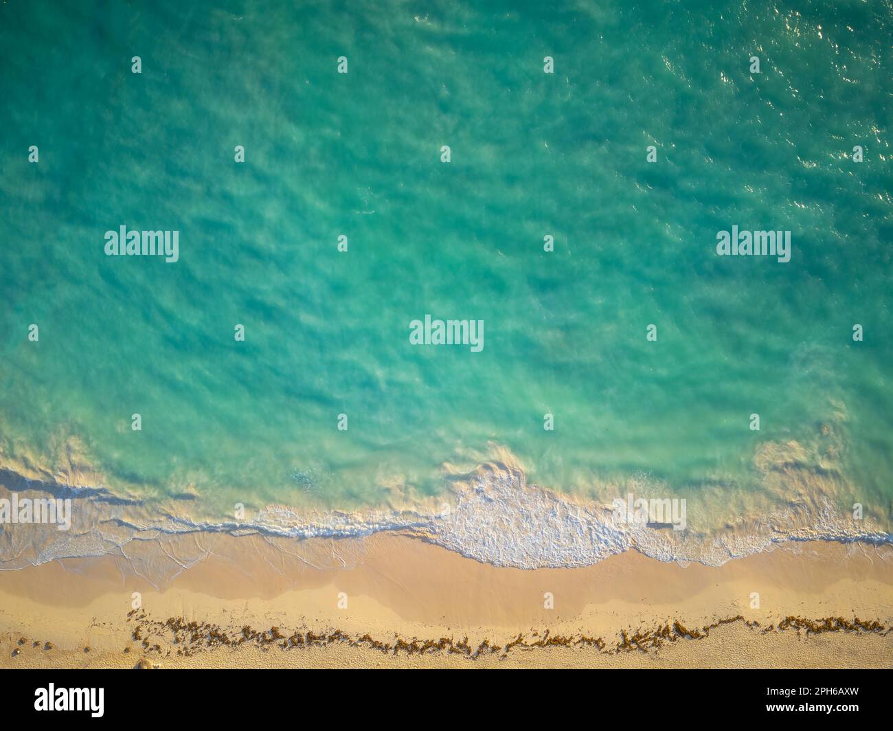 Sandy shore and sea wave. Clear emerald water. Stunning seascape. Minimalism. Rest on the sea, swimming, fishing, relaxation, ecology, weather. Stock Photo