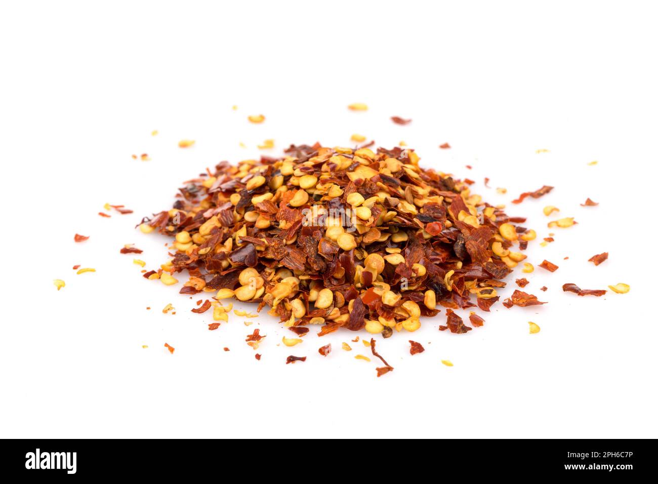 The pile of a crushed red pepper, dried chili flakes and seeds isolated