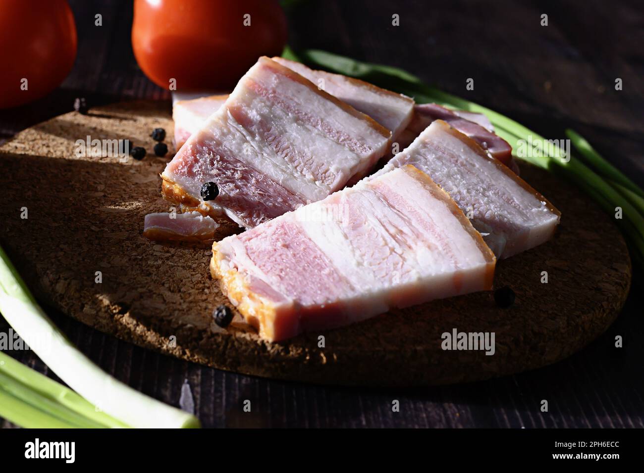 lard with black bread and green onions on a dark background, Russian