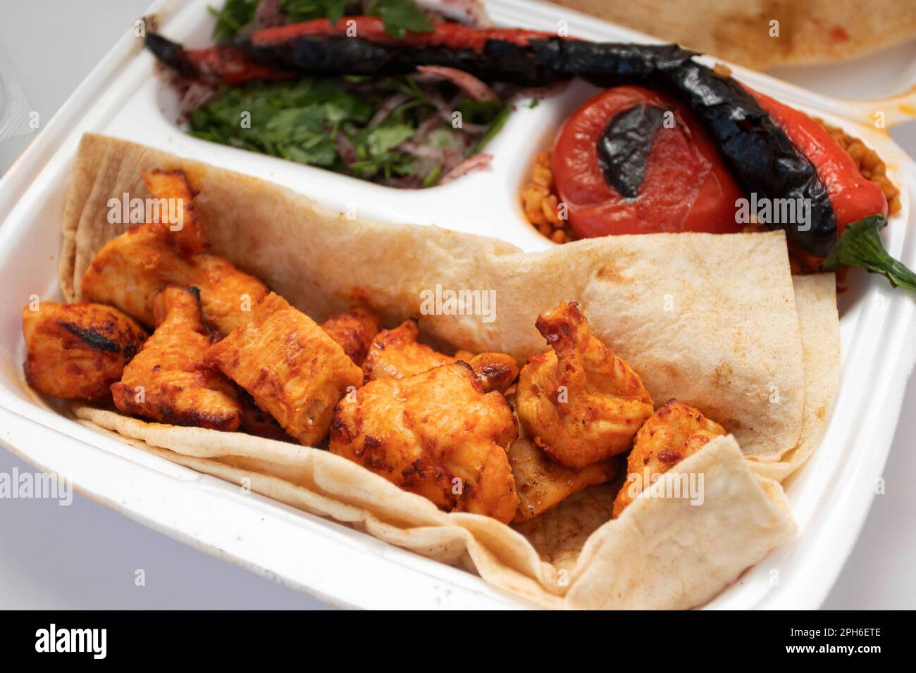 Shish kebab and pita bread on a disposable plate. Turkish food. Food delivery Stock Photo