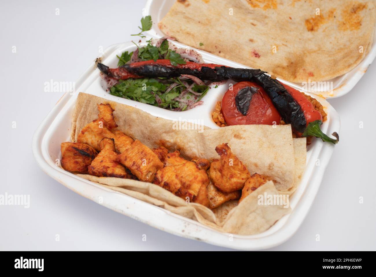 Shish kebab and pita bread on a disposable plate. Food delivery. Stock Photo