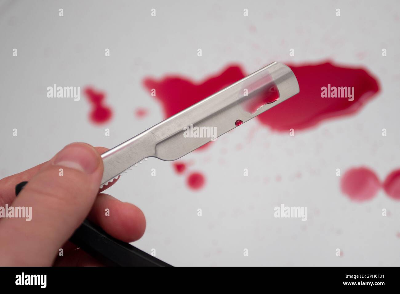 straight razor and Drops of blood Stock Photo