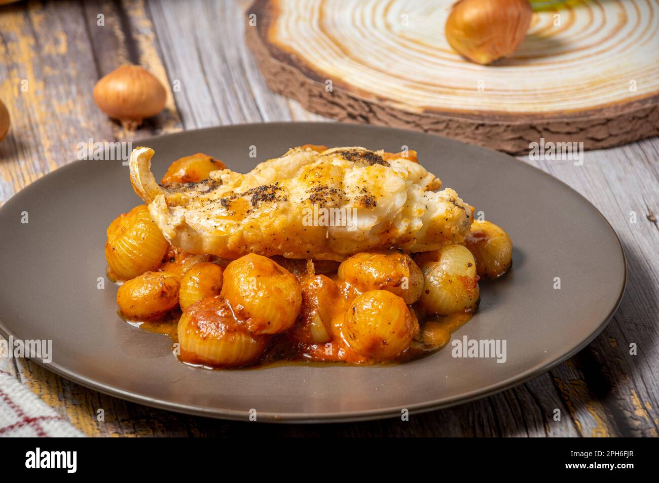 Traditional greek stifado with cod fish Stock Photo Alamy