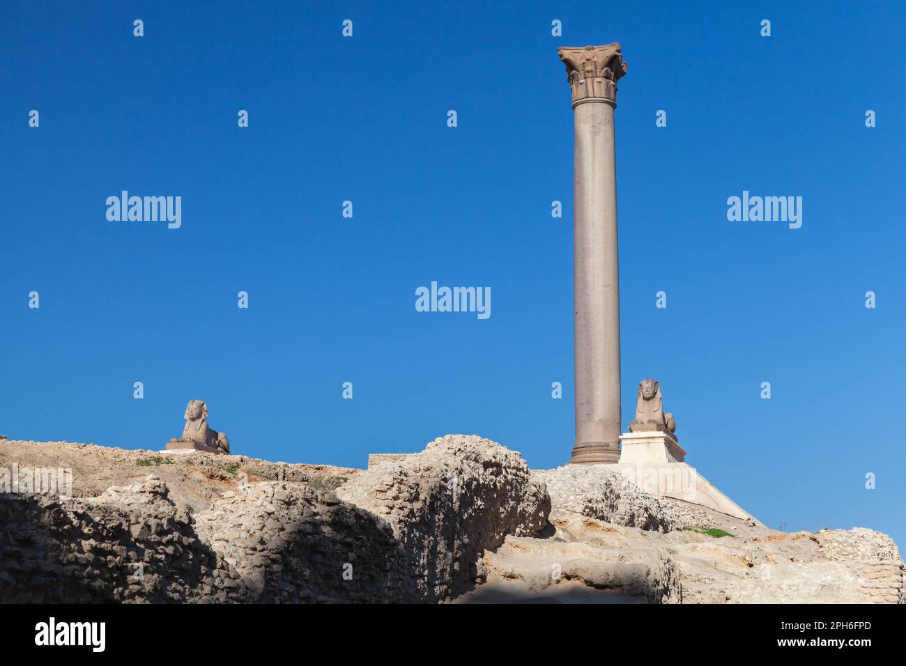 Alexandria, Egypt. Ancient stone sphinxes are near the Pompeys Pillar ...