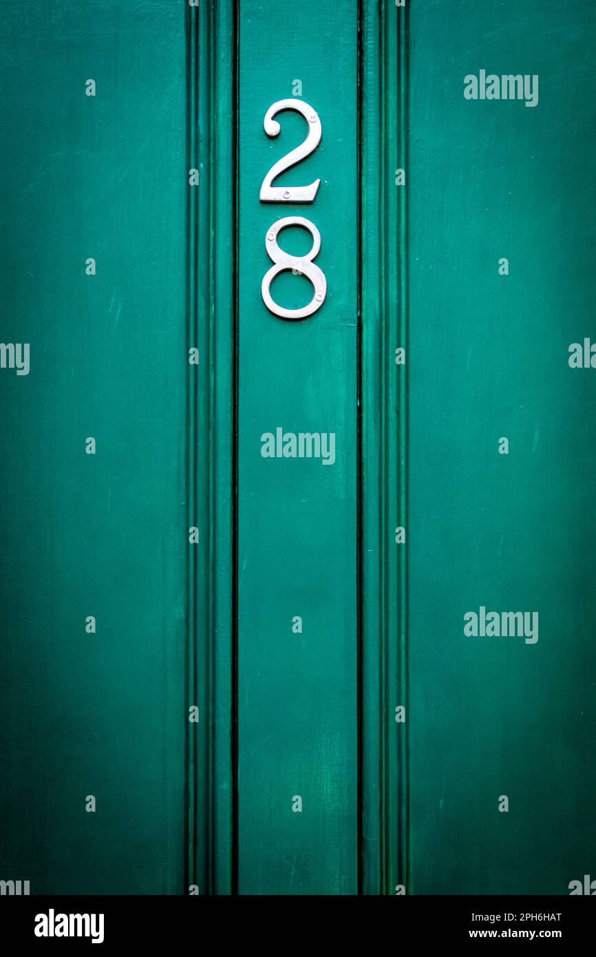 House door number 28 in pleasant dark green Stock Photo