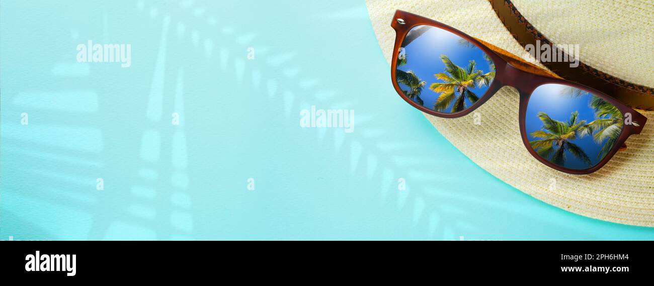 concept vacation and summer travel banner. Happy holidays on sandy tropical sea beach. Panama hat and sunglasses with a reflection of the sandy trovic Stock Photo