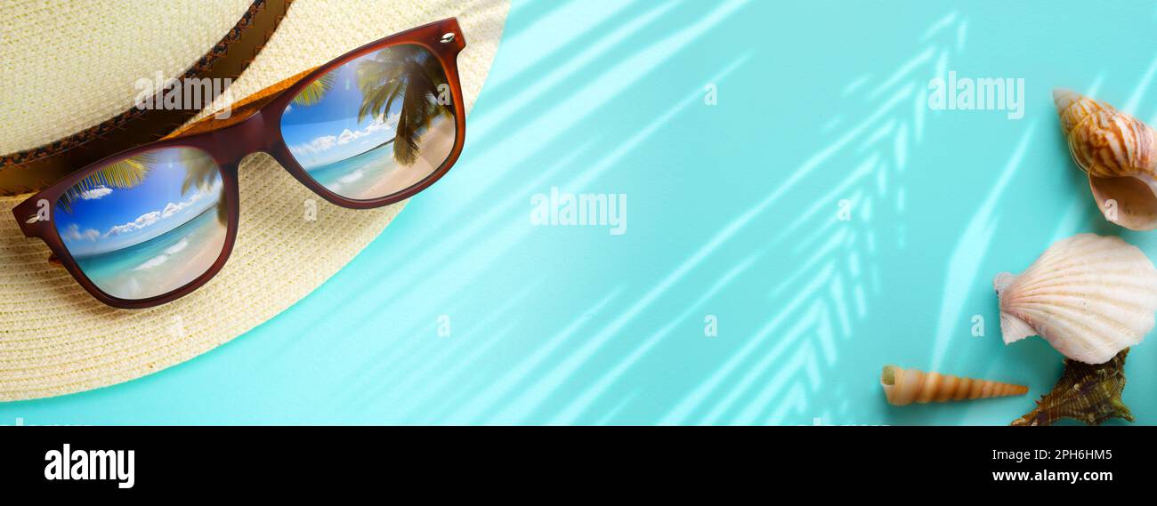 concept vacation and summer travel banner. Happy holidays on sandy tropical sea beach. Panama hat and sunglasses with a reflection of the sandy trovic Stock Photo