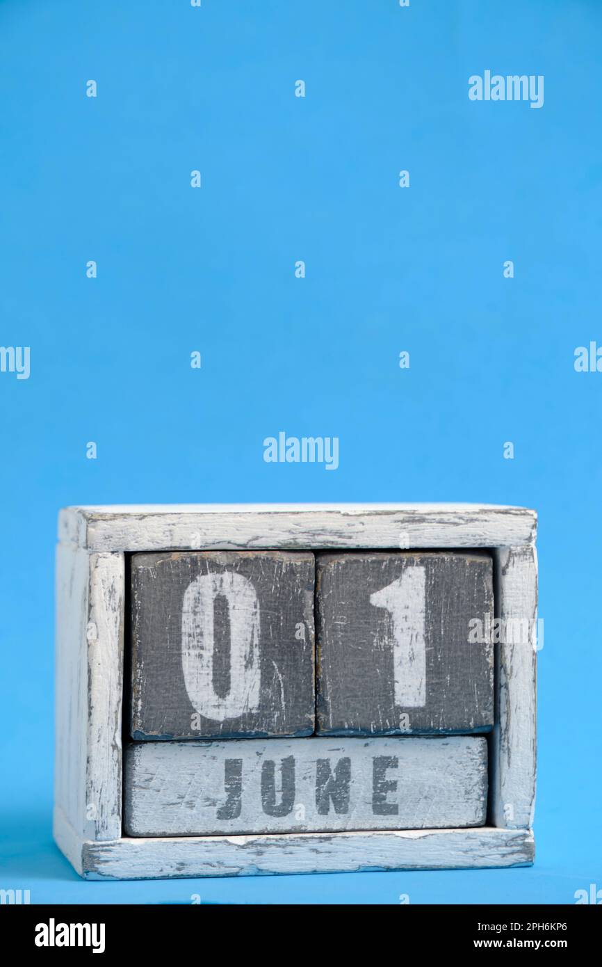 June 01 Letters Calendar for June 01 made wooden cubes standing blue background. With ...