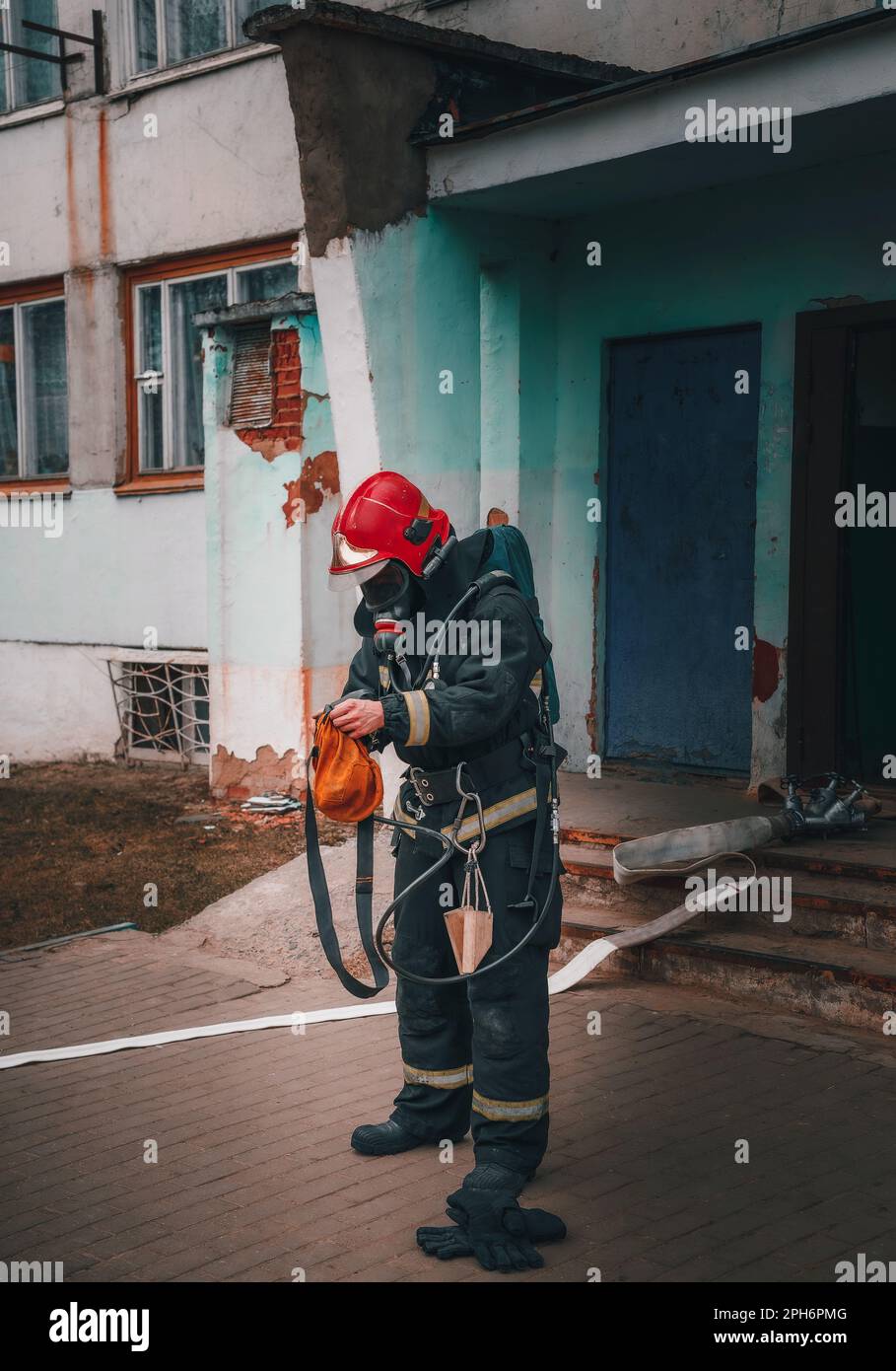 firefighter man preparing to extinguish the fire checking ammunition Stock Photo