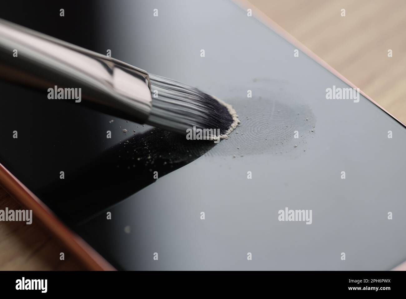 Brush processes fingerprints on screen of modern smartphone Stock Photo