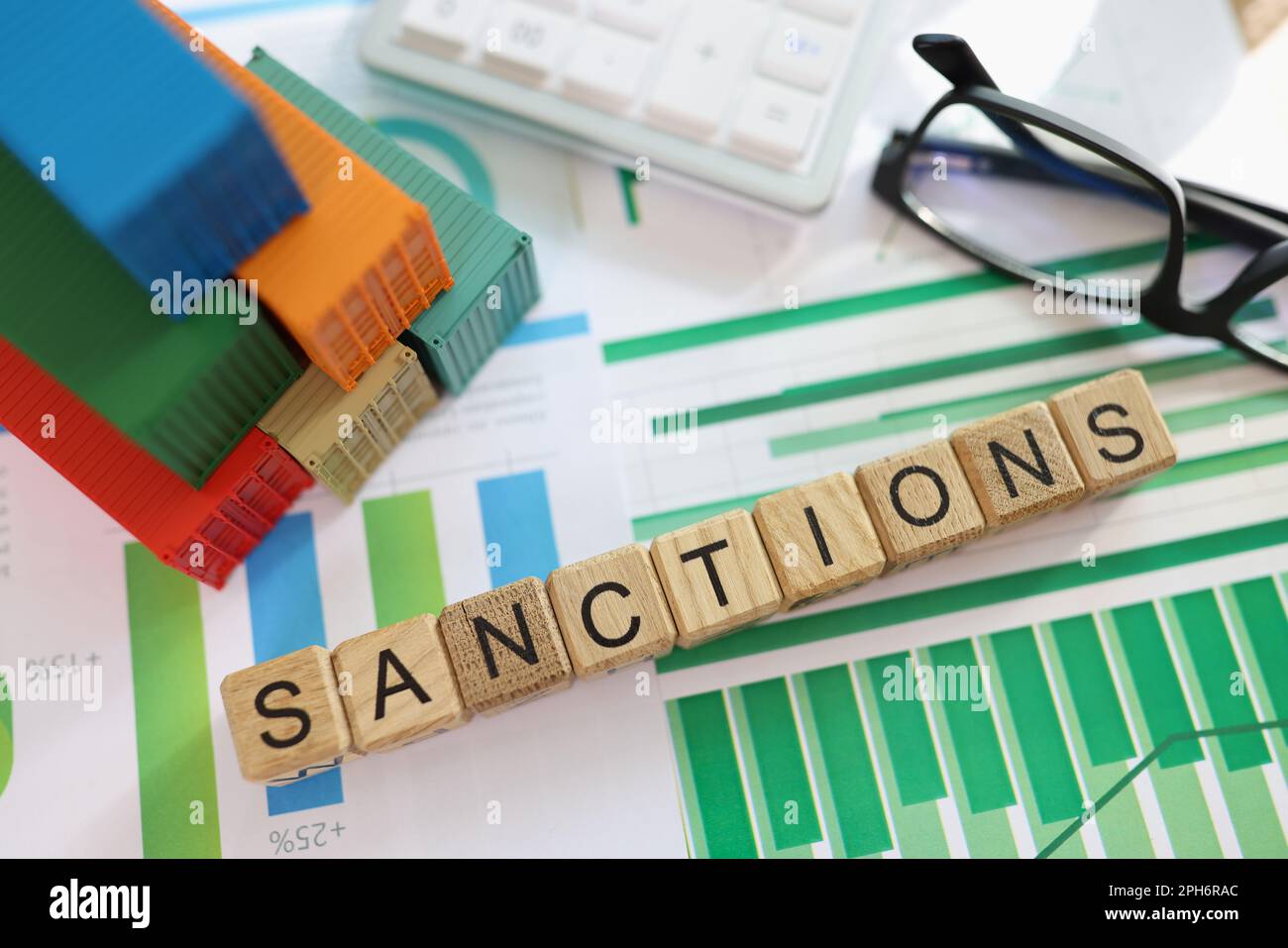 Word Sanctions with wooden blocks on diagrams in office Stock Photo