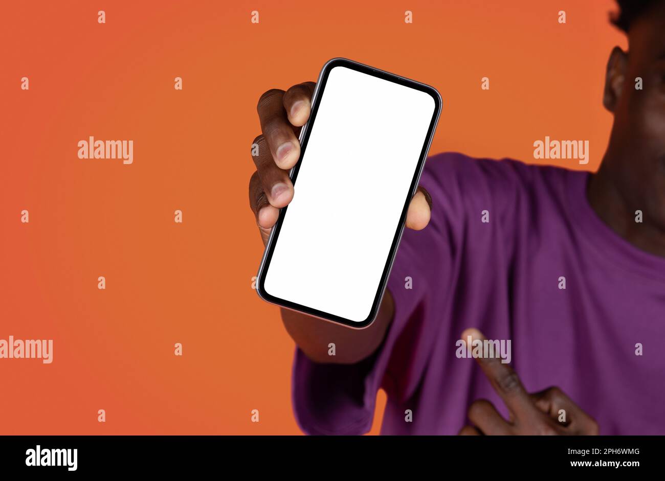 Black man holding cell phone with blank screen, mockup Stock Photo