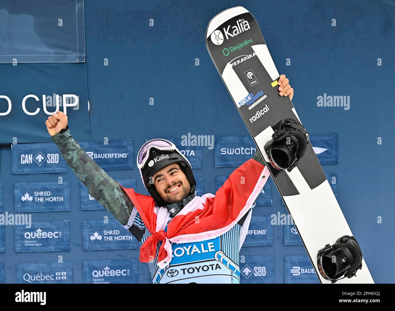 Eliot Grondin, of Sainte-Marie Quebec, celebrates his third place finish at the FIS snowboard cross world cup event in Beaupre, Quebec, Sunday, March 26, 2023
