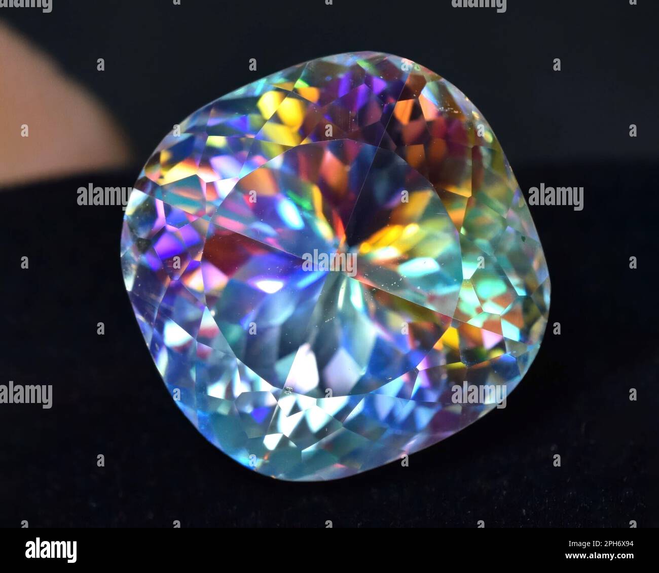 Natural gem rainbow quartz on gray background Stock Photo