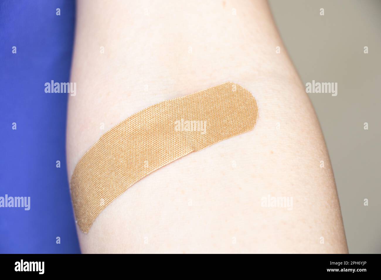 a plaster on the arm after taking blood from a vein, taking tests Stock Photo