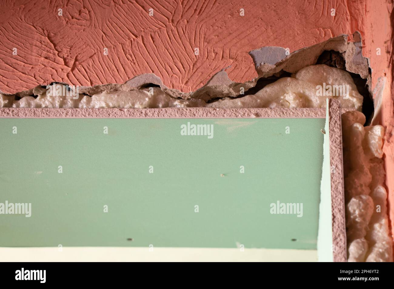 the wall is sheathed with moisture-resistant green plasterboard in the apartment, renovation work at home Stock Photo