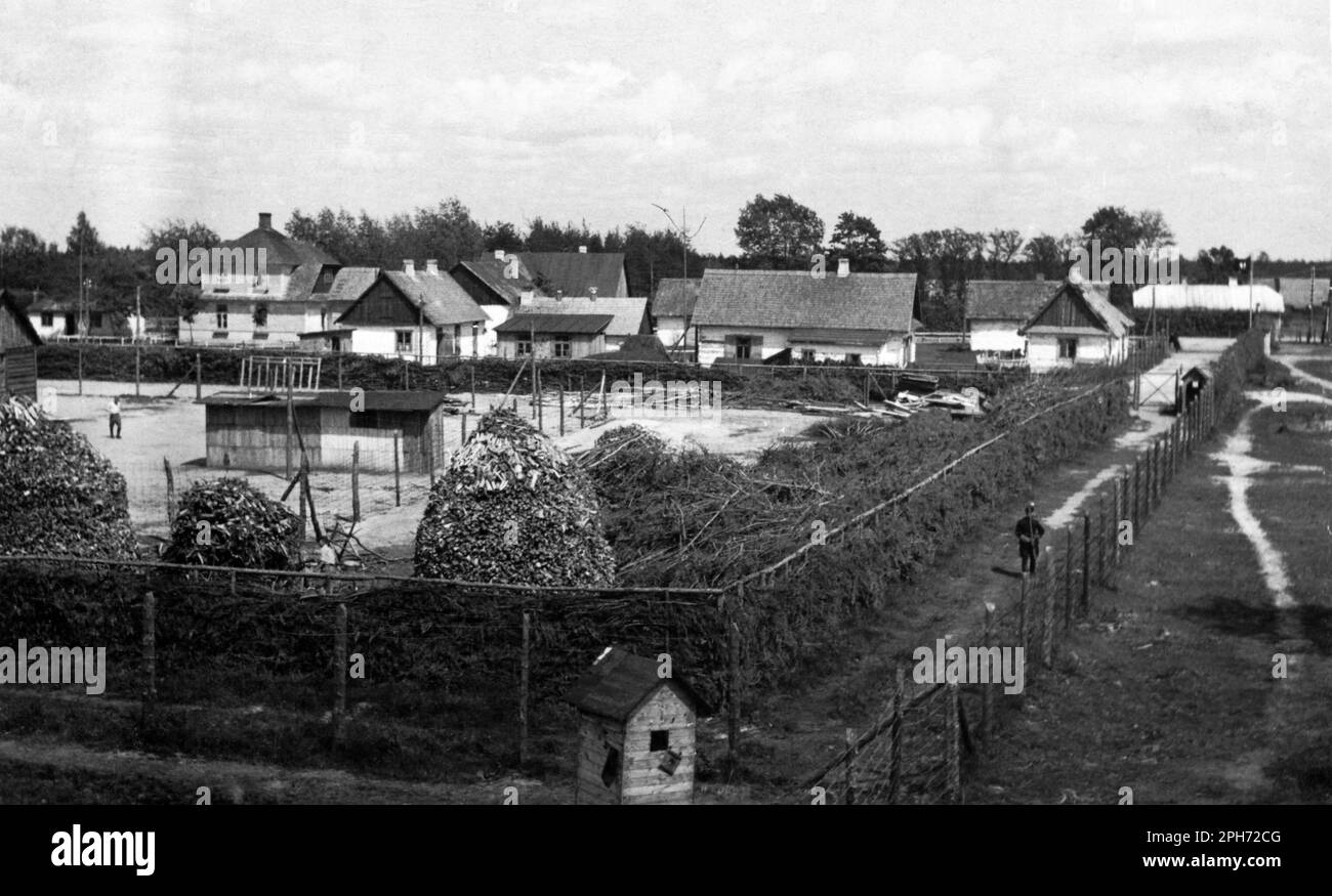 A view of the Sobibor extermination camp in summer 1943. The yard in the foreground is Lager I. Part of the village of Sobibor was incorporated into the extermination camp and the quiant houses with their expressive names helped allay the fears of new arrivals before they were led to their deaths on the gas chambers. Stock Photo