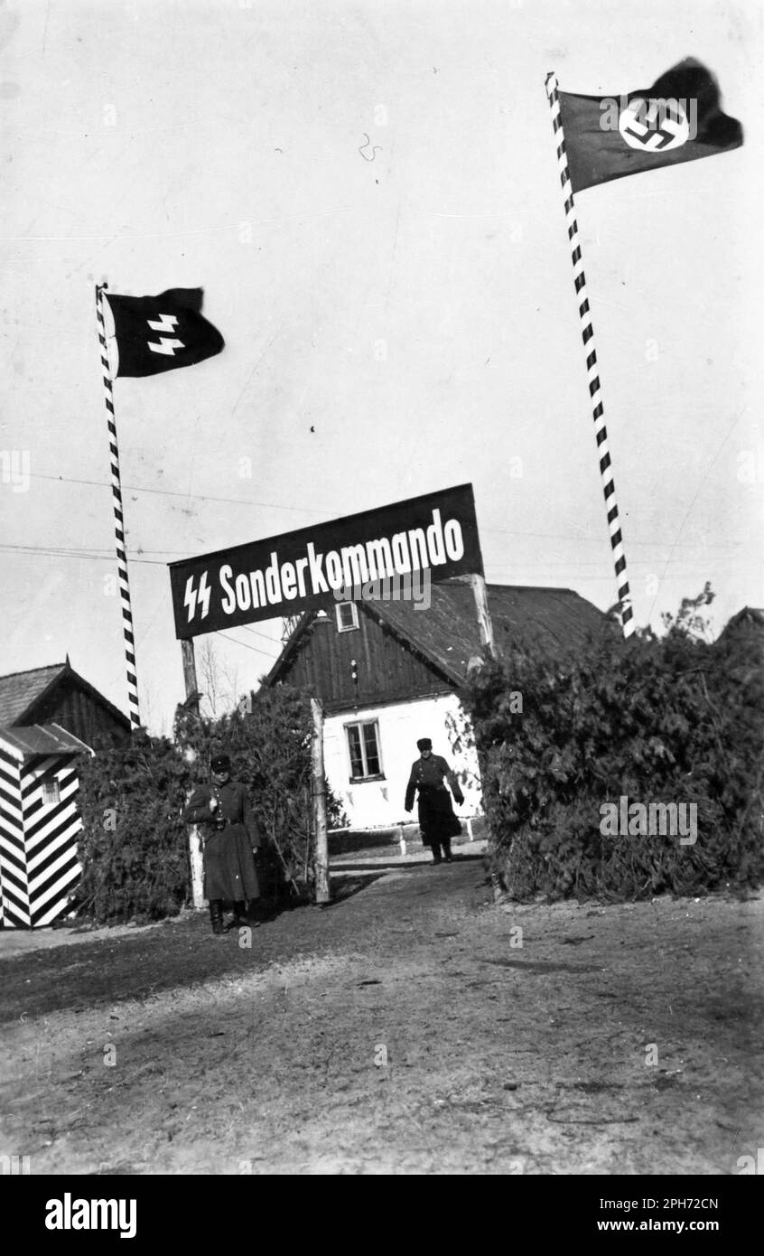 The main gate as it appeared in March 1943. The fence was thatched with pine branches in order to block the view inside. Part of the village of Sobibor was incorporated into the extermination camp and the quiant houses with their expressive names helped allay the fears of new arrivals before they were led to their deaths on the gas chambers. Stock Photo