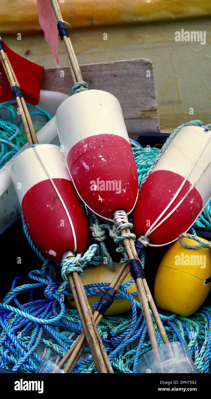 Red and white striped fishermen's floats on top of a pile of blue ...
