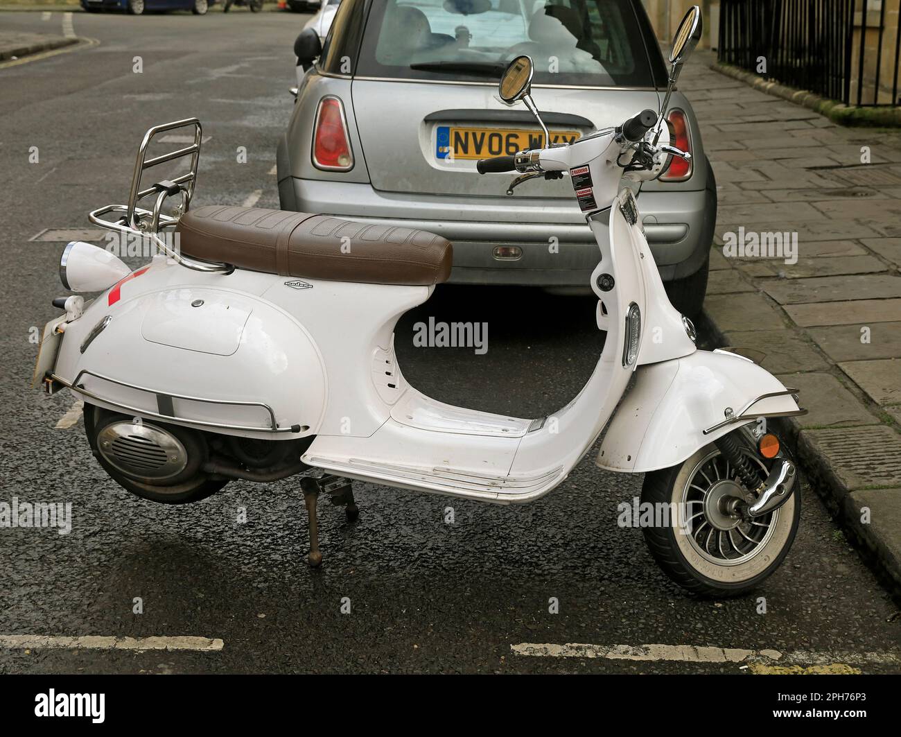 White Modena motor scooter parked on its stand by the kerbside.  With L plates - learner driver. Taken March 2023 Stock Photo