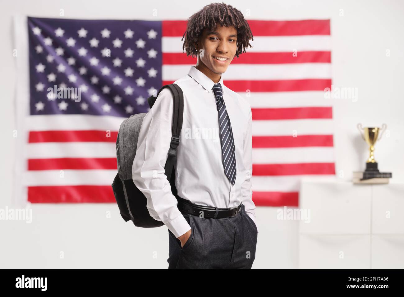 African american male student with a backpack wearing a college uniform ...
