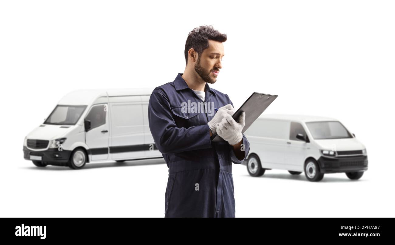 Auto mechanic worker writing a document in front of two white vans ...