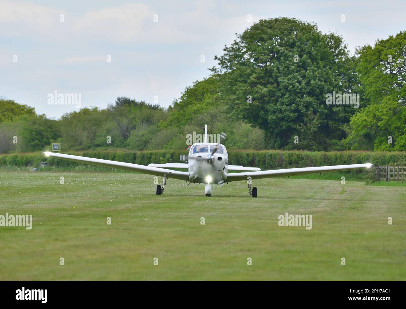 Piper PA-32-301FT, registered G-TAAT, taxis towards the parking area after arriving at Compton Abbas Airfield. Stock Photo