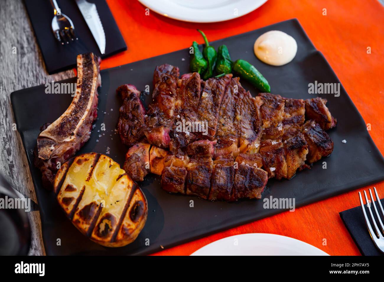 Beef sirloin steak with baked green pepper and potatoes Stock Photo - Alamy