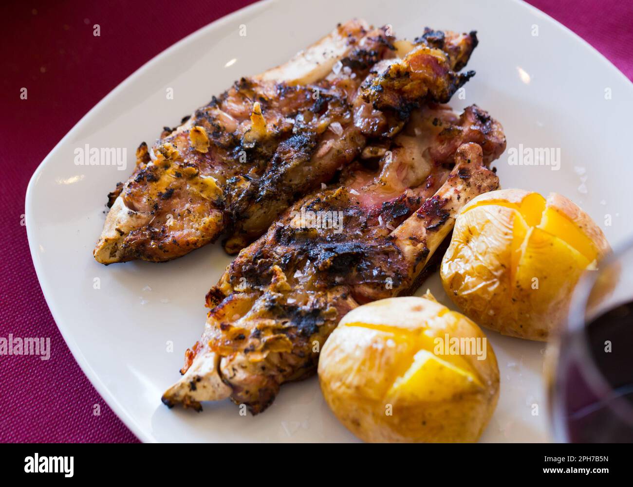 Grilled pettitoes with baked potatoes Stock Photo