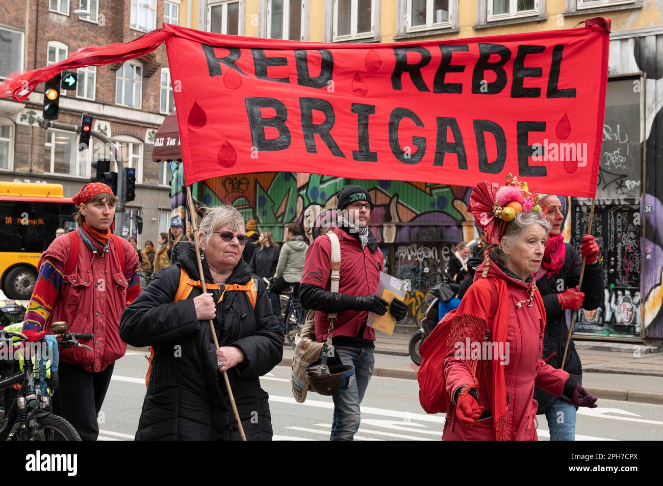Red rebel brigade protesters and Extinction Rebellion marching through the streets of Copenhagen, Denmark, 25 th March, 2023 Stock Photo