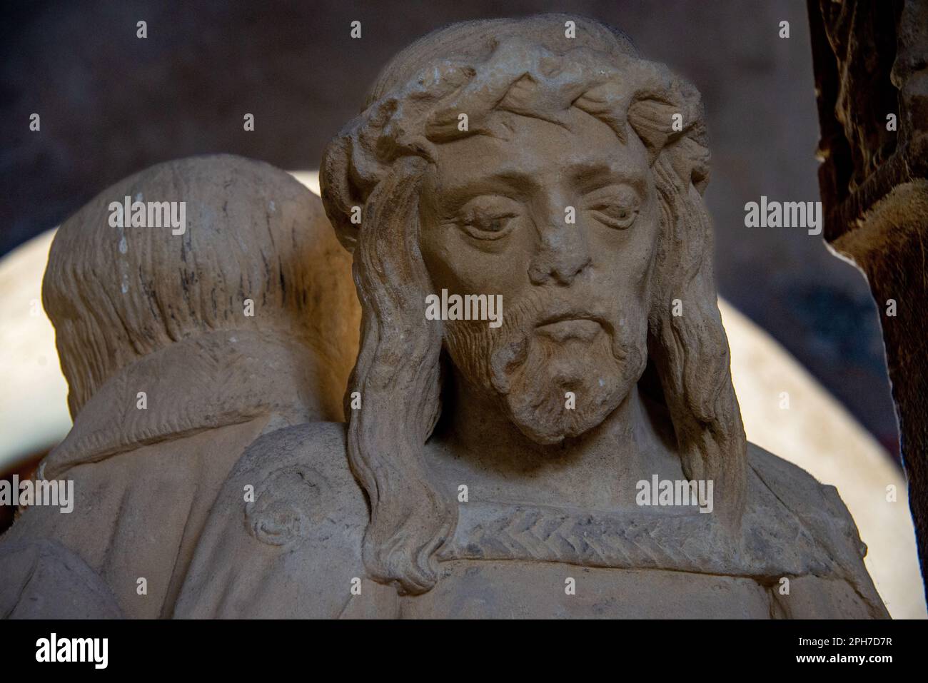 Figures of a medieval crucifixion group carved from stone on display at