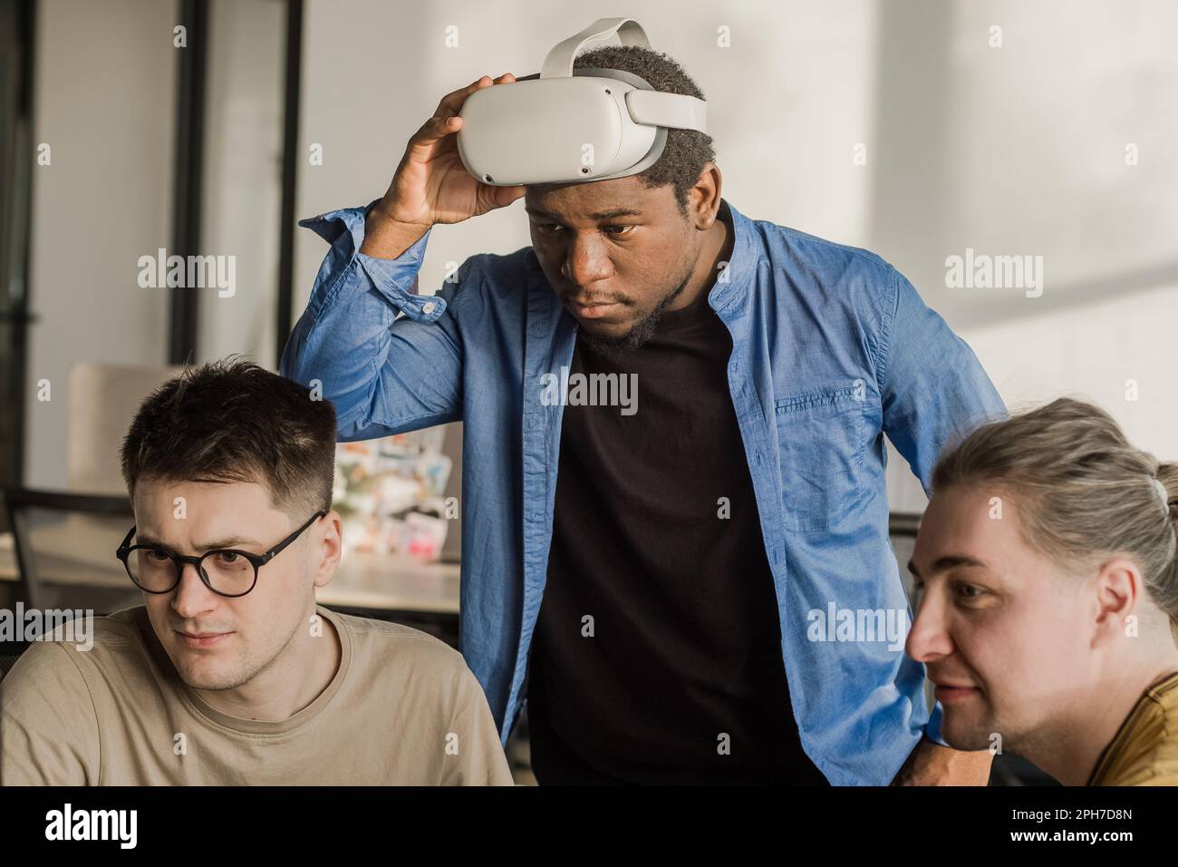 IT Development Team Working on VR Project. Man wearing VR headset ...