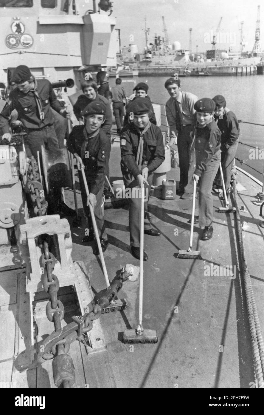 BOY SCOUTS FROM THE ISLE OF WIGHT SCRUB THE DECKS OF HMS WILTON IN