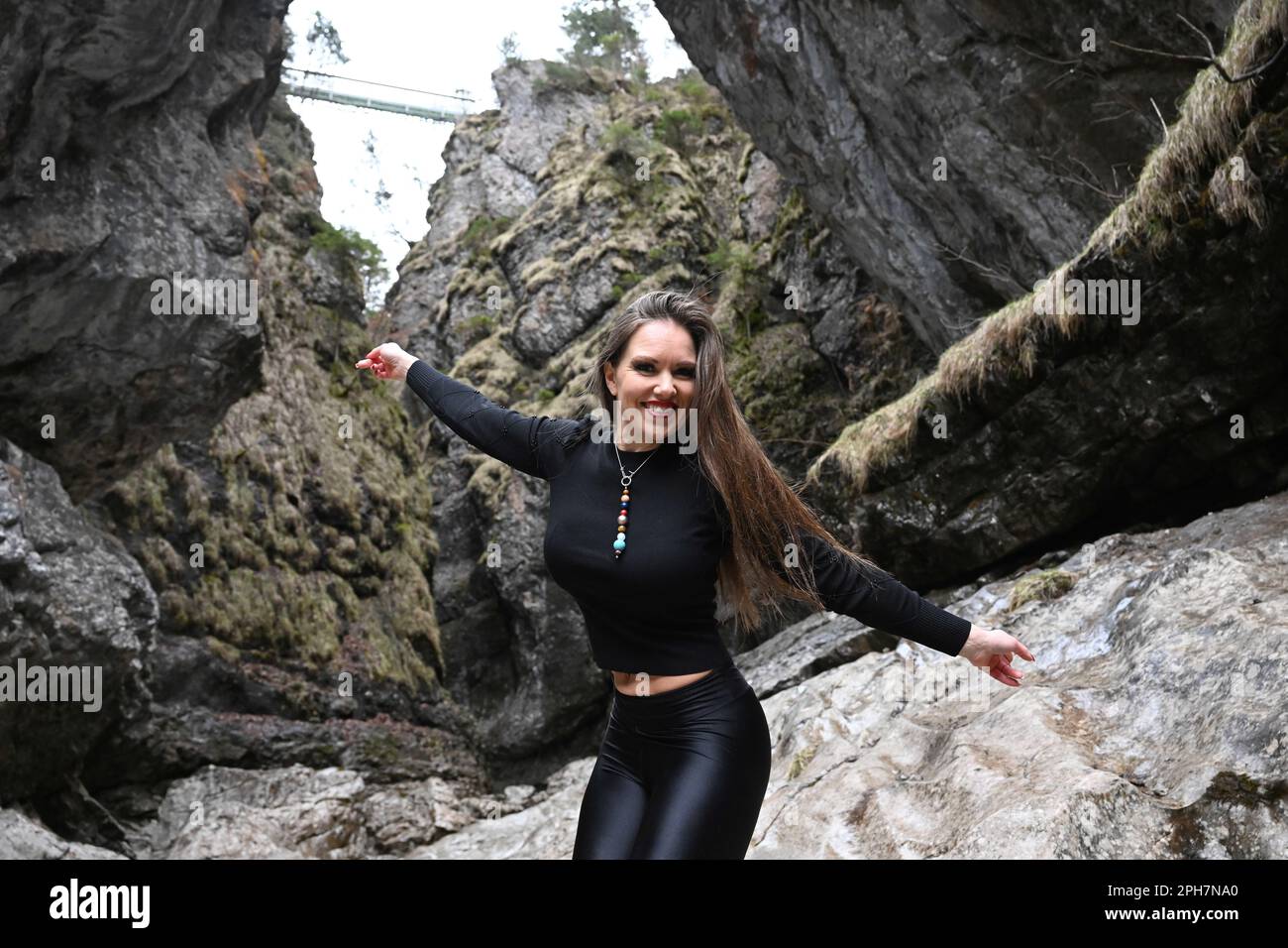 Eschenlohe, Germany. 26th Mar, 2023. Spacewoman Diane Löbel shows off in the Asam Gorge during a video art shoot for the www.colourfuluniverse.space project. Credit: Felix Hörhager/dpa/Alamy Live News Stock Photo