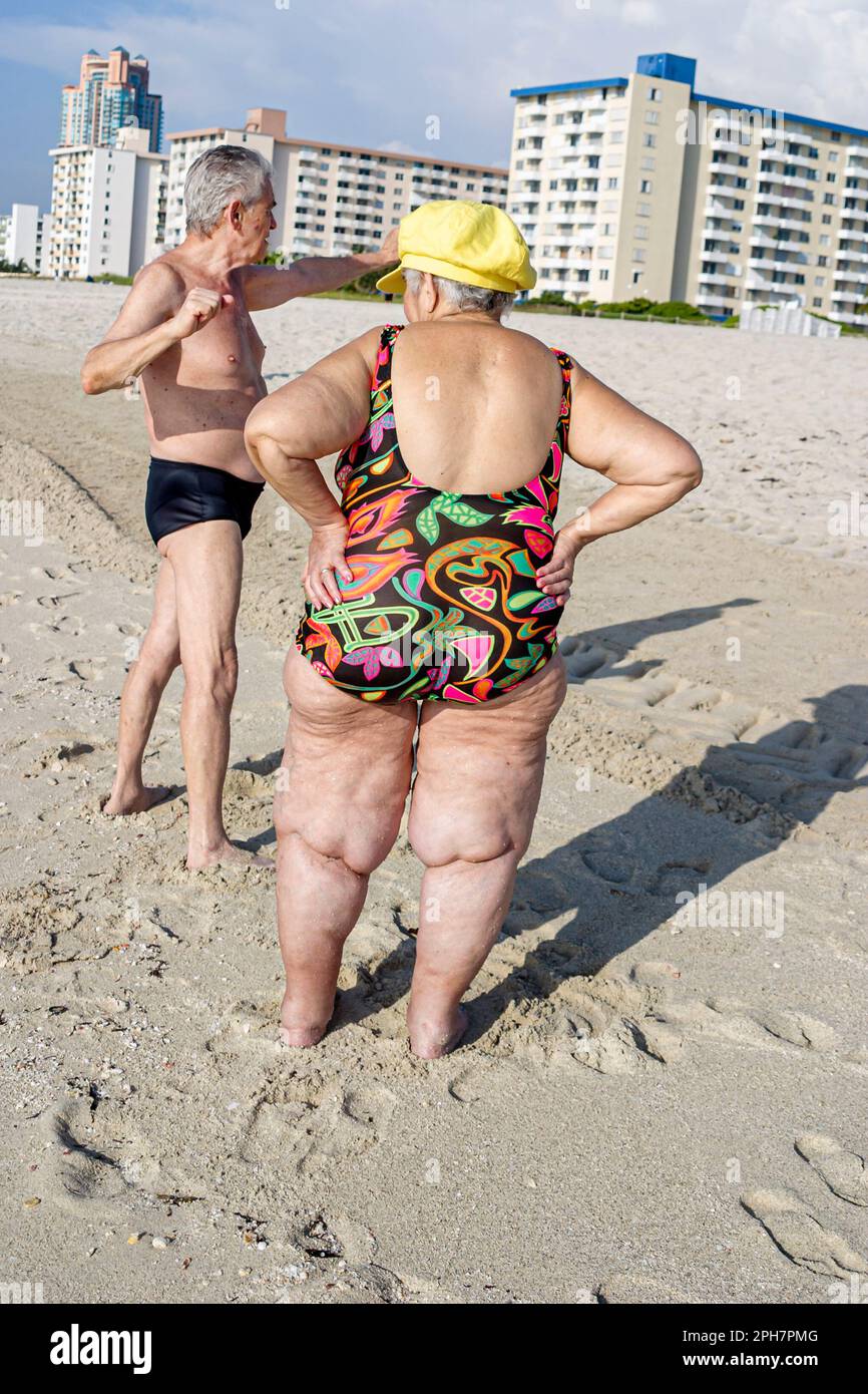 Miami Beach Florida,Eastern European Jewish immigrant sunbather,sunbathing,sand,surf,sun,overweight obese obesity fat heavy plump rotund stout,visitor Stock Photo