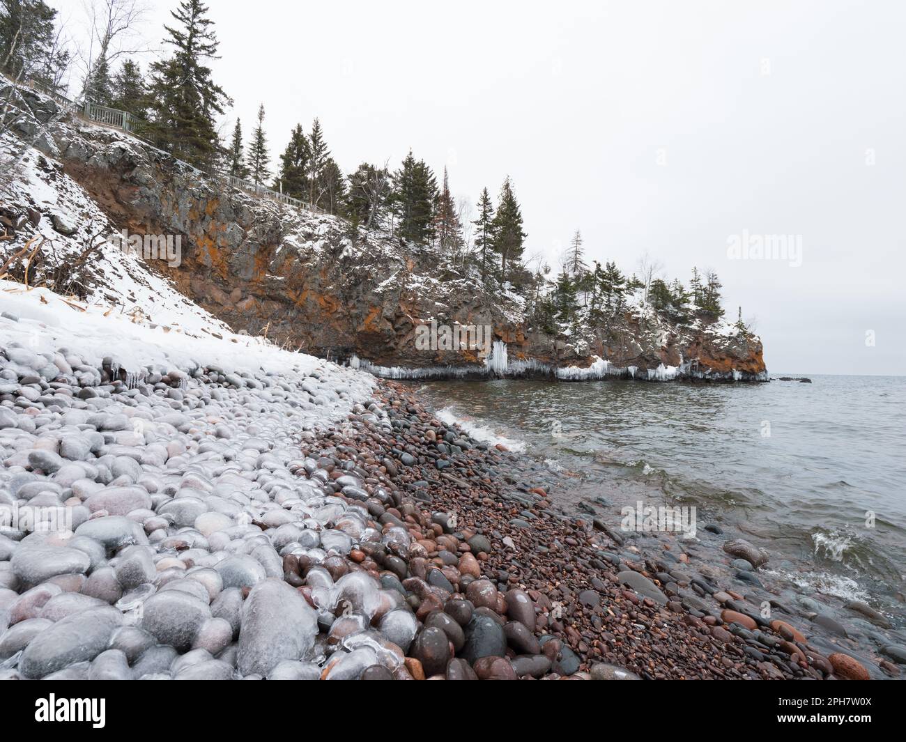 Ice coated pebbles along the shoreline of Lake Superior at the Tettegouche State Park, MN Stock Photo