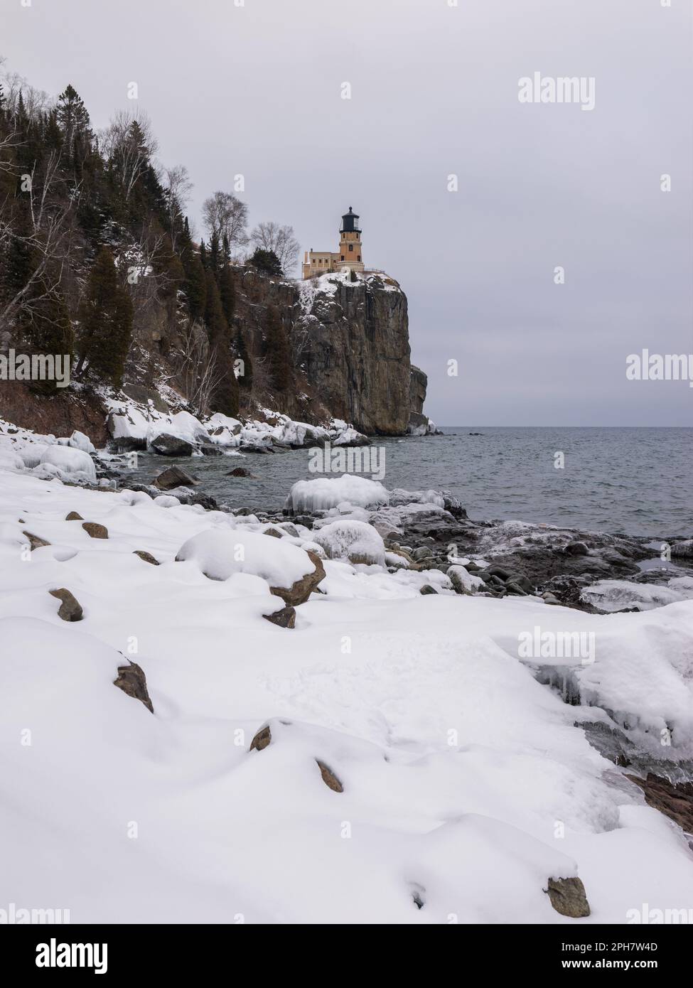 Shoreline of Lake Superior norther shore in wither with Split Rock Lighthouse in the background Stock Photo
