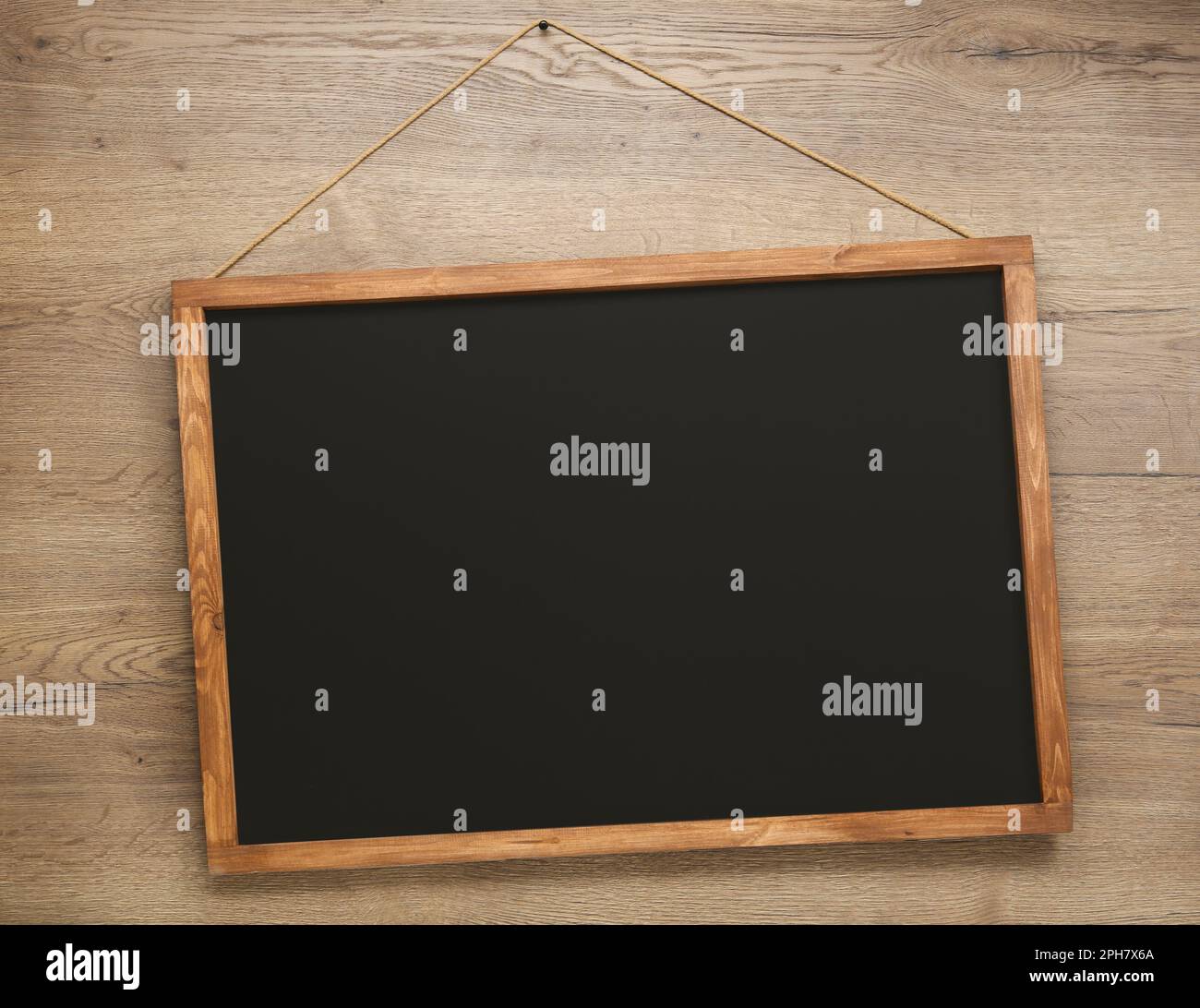 Clean black chalkboard hanging on wooden wall Stock Photo - Alamy