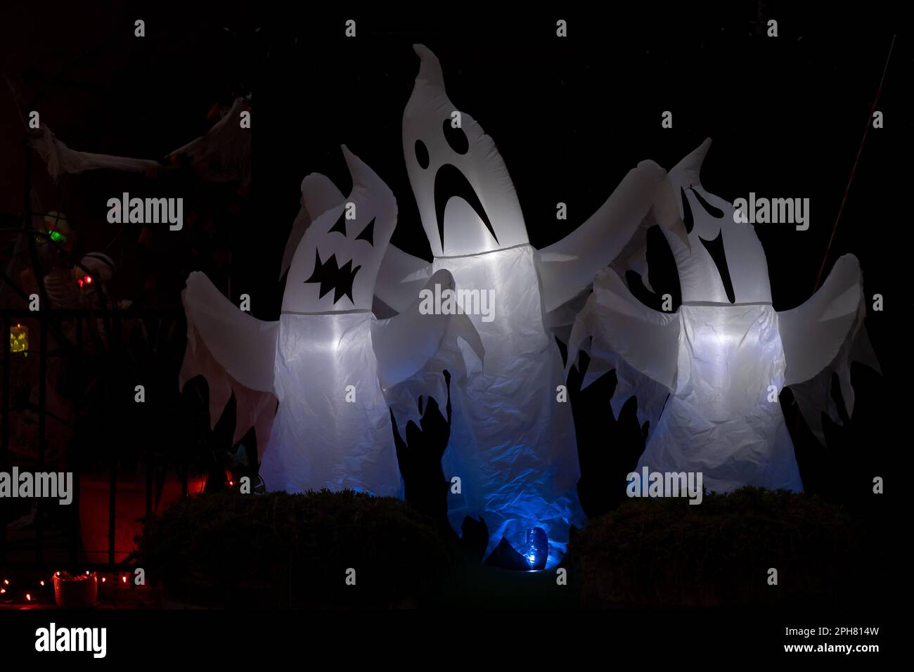 Scary inflatable ghosts Halloween deccoration outdoors at night Stock Photo