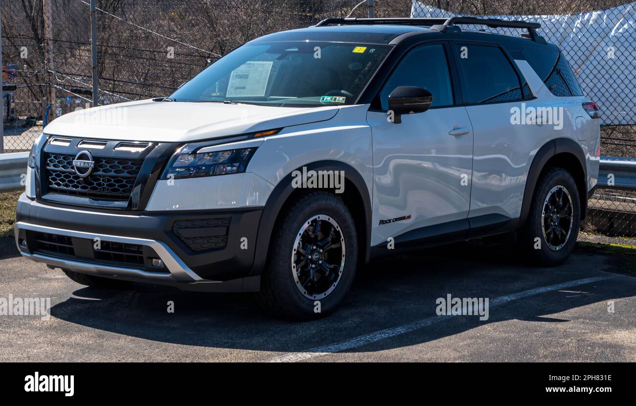 A new, white Nissan Pathfinder Rock Creek SUV for sale at a dealership