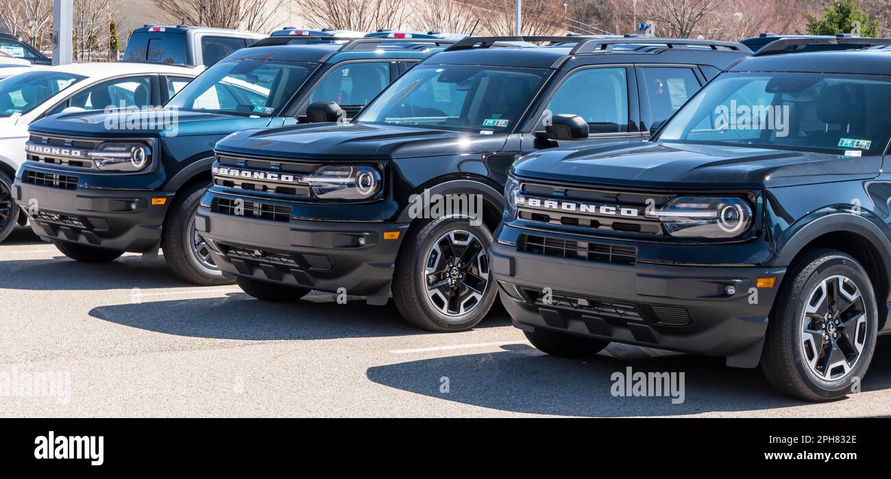 Three black Ford Bronco SUVs lined up for sale at a dealership in