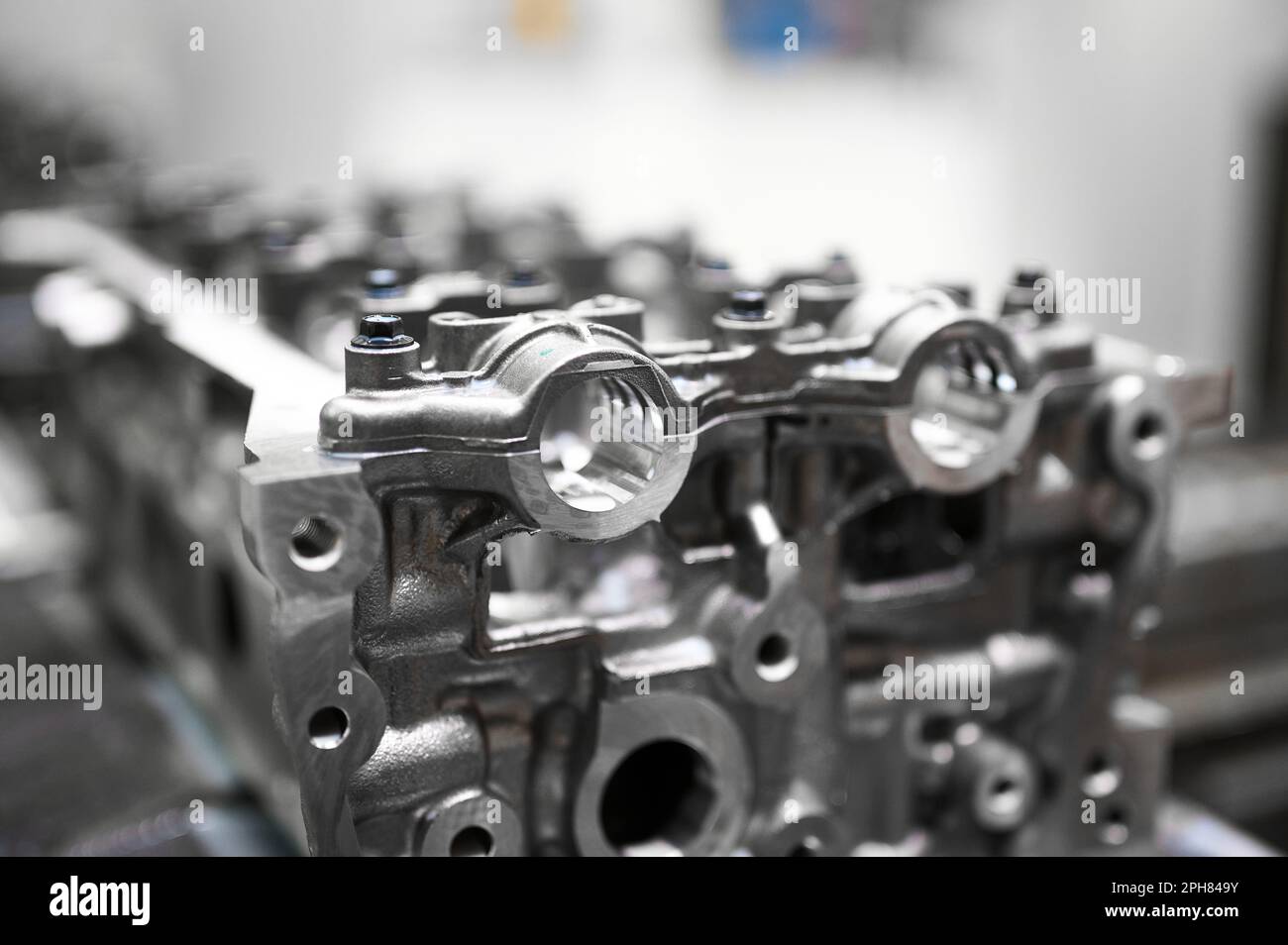 Car engine cylinder heads in housings on conveyor in shop Stock Photo