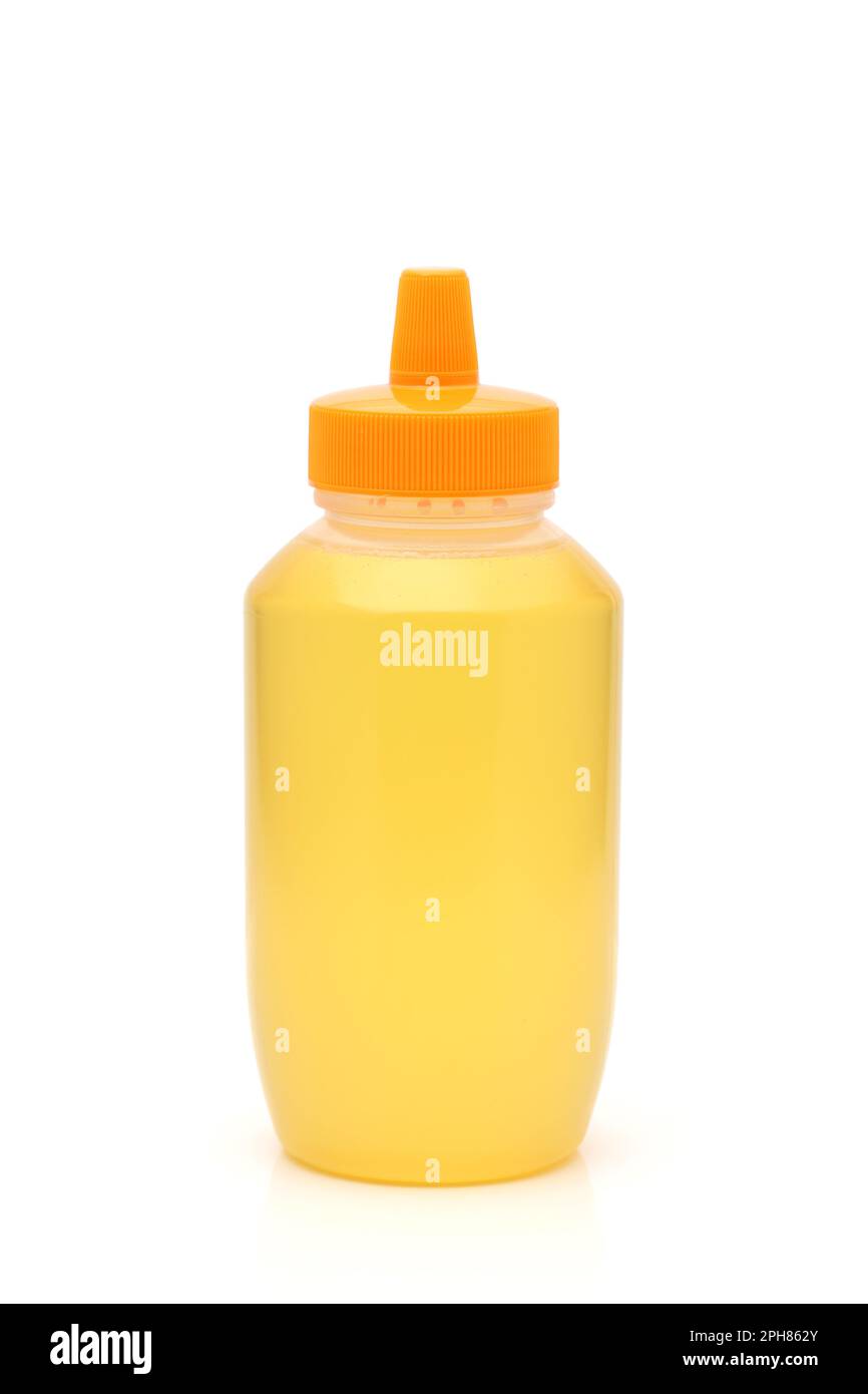 Plastic bottle of honey on white background Stock Photo