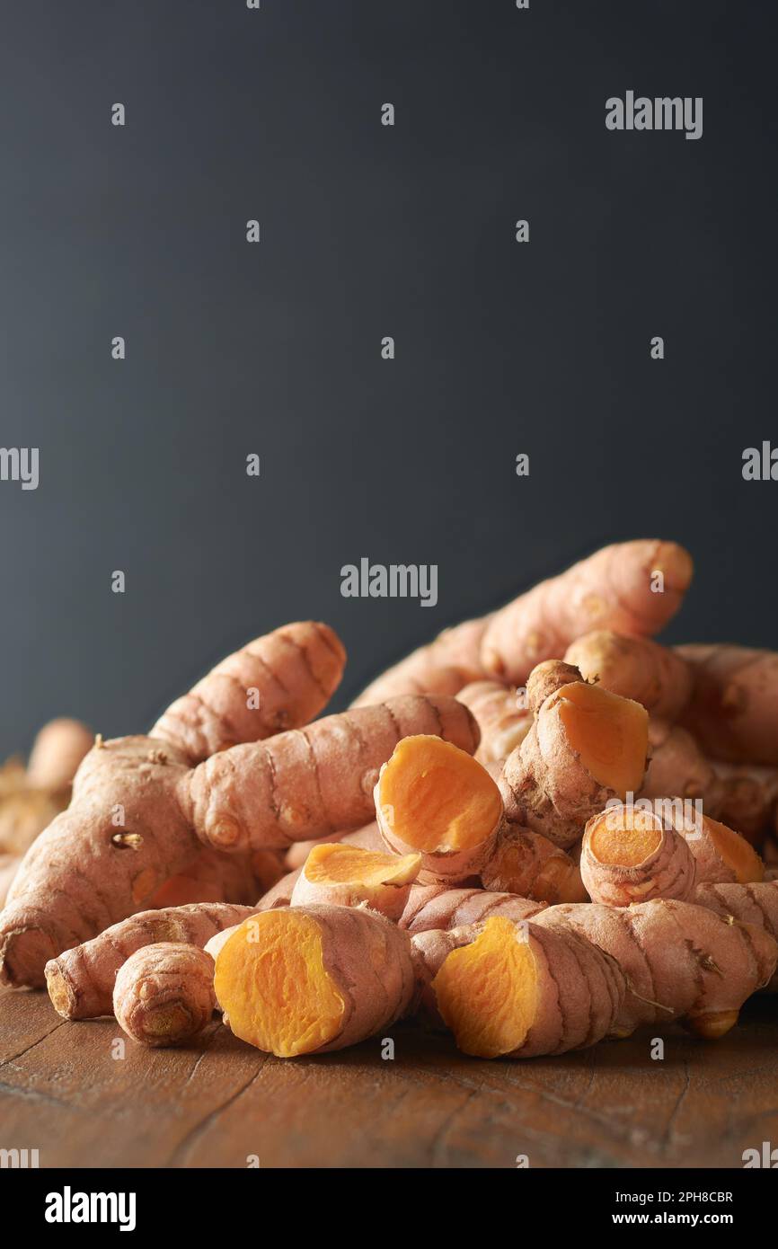 closeup side view of cleaned turmeric rhizomes or roots, curcuma longa
