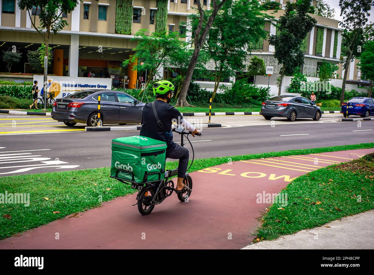 Grab food delivery rider on his e bike rushing to provide more