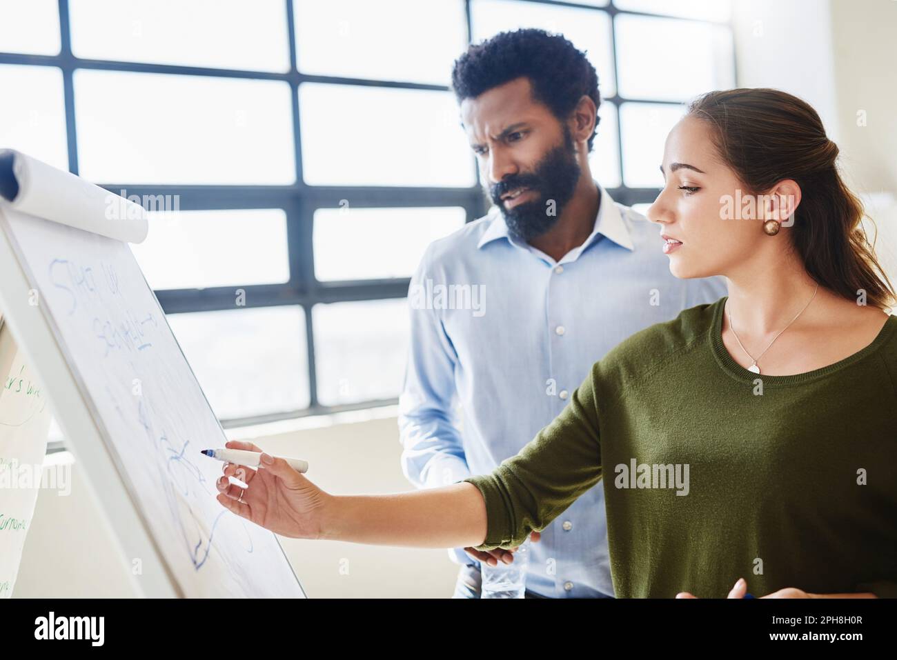 Plan and execute. two businesspeople brainstorming together in an office. Stock Photo