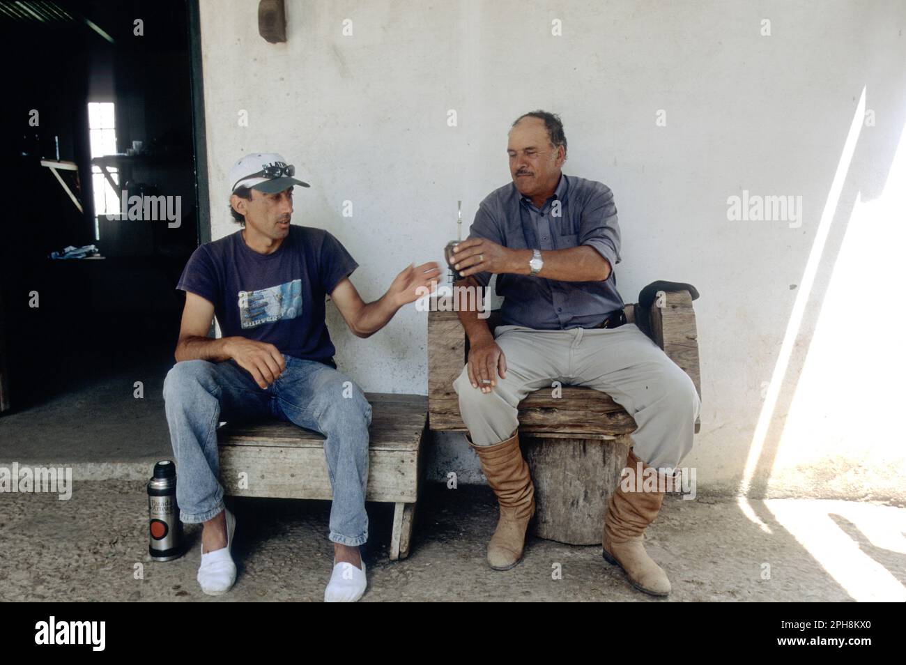 Two Uruguayan men sharing Yerba Mate at historic San Pedro Del Timote Estancia, Uruguay, South America. Stock Photo
